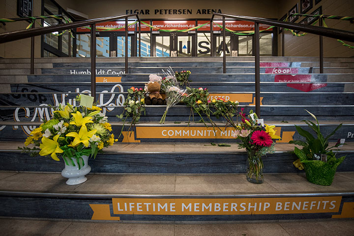 Community members leave notes and flowers at a memorial for the Humboldt Broncos team leading into the Elgar Petersen Arena in Humboldt Saskatchewan, April 7, 2018.