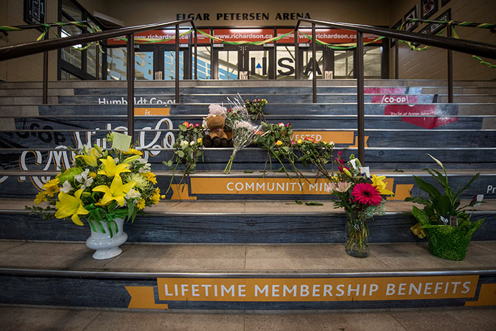 Community members leave notes and flowers at a memorial for the Humboldt Broncos team leading into the Elgar Petersen Arena in Humboldt Saskatchewan, April 7, 2018.  