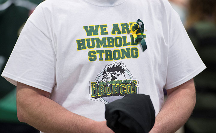 A man wears a Humboldt Broncos shirt during a vigil at the Elgar Petersen Arena in Humboldt, Saskatchewan, April 8, 2018.