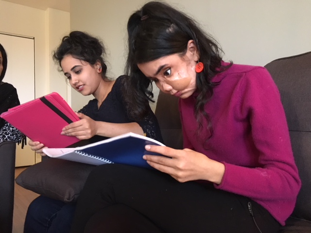 Shakila Zareen, reading at right, beside her sister Samira Sediqi, left.