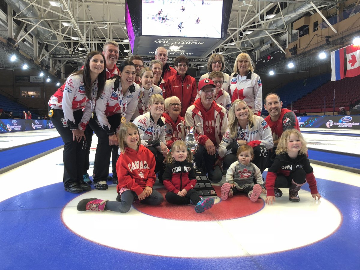 Team Canada and their families celebrate their win at the World Women’s Curling Championship.