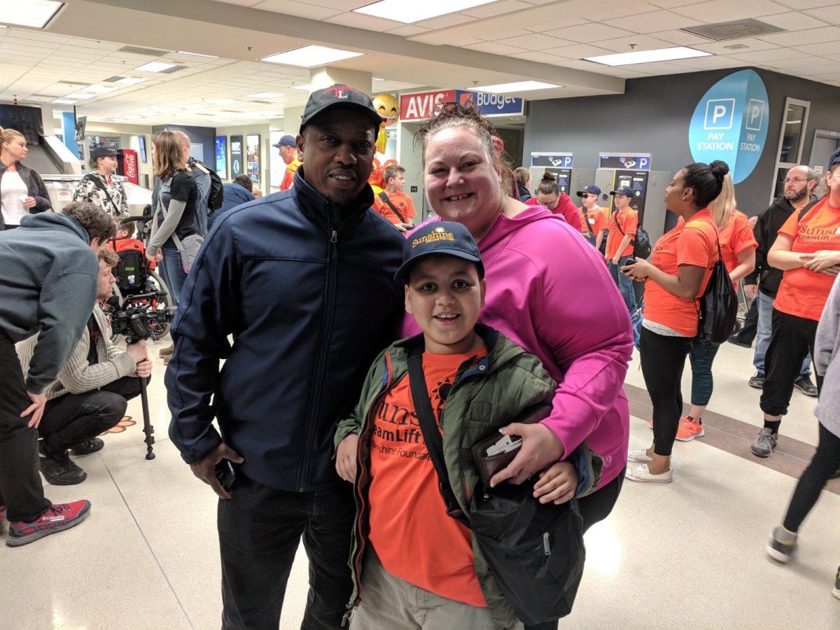 Miles with his mom and dad before flying to Florida for a day trip at Walt Disney World.