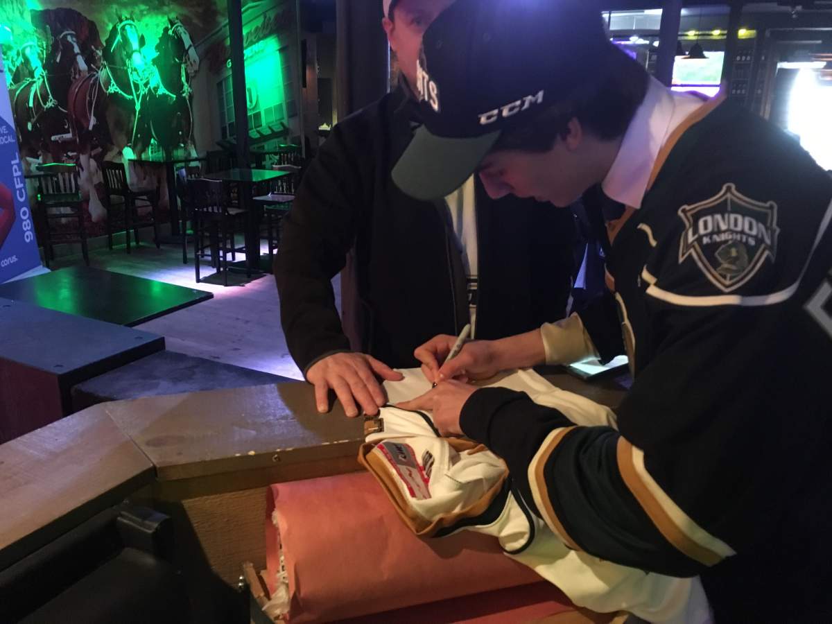 London, Ont. native Luke Evangelista signs his first autograph as a member of the London Knights after being selected 14th overall in the 2018 OHL draft.