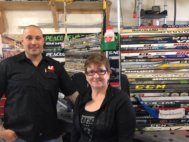 Shaun Wagstaff and Laurie Brigan stand with one of two hockey stick benches they’re building to help support Ryan Straschnitzki and his family as he recovers from the Humboldt Broncos bus crash.