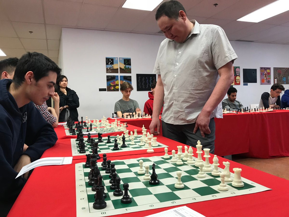 Bator Sambuev playing chess with students from Vanier College on Wednesday, April 25, 2018.