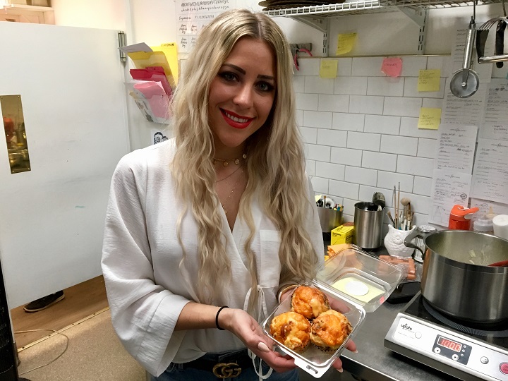 Jenna Illchuck, co-owner of Jenna Rae Cakes, holds three Jumbo Jet Dog muffins.