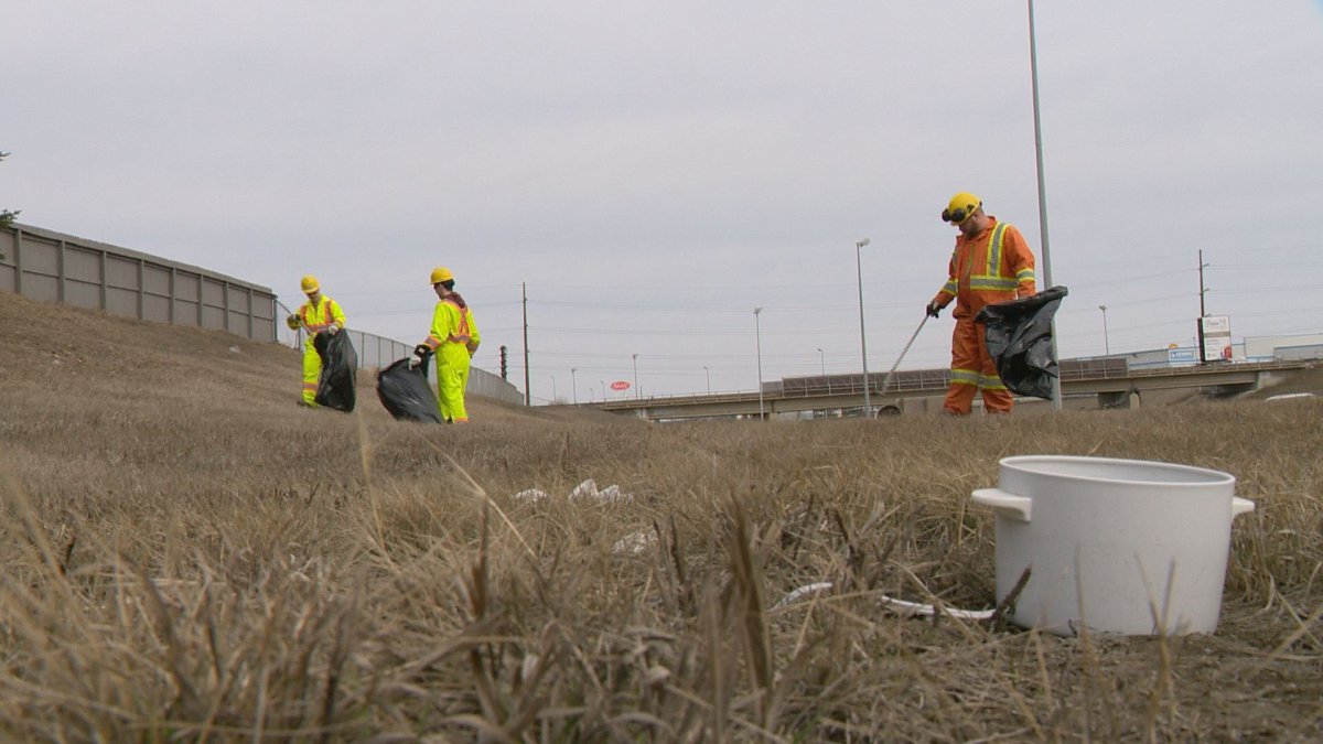 City crews gather trash off of Ring Road. 