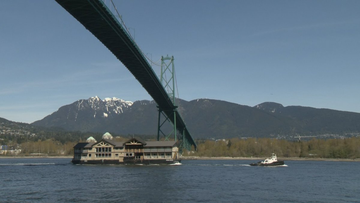 Ocean House, a high-end resort, being towed under the Lions Gate Bridge before it's taken to Haida Gwaii.