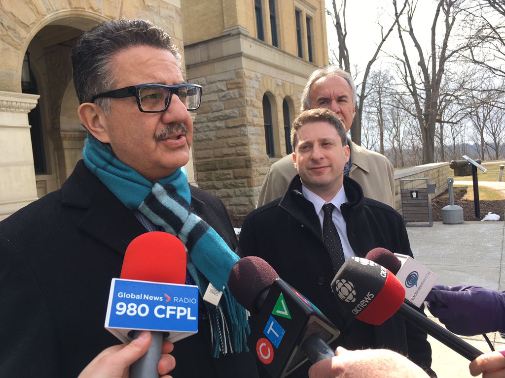 Steven Skurka addresses reporters with his client, Mark Phillips (middle), and co-counsel (right).