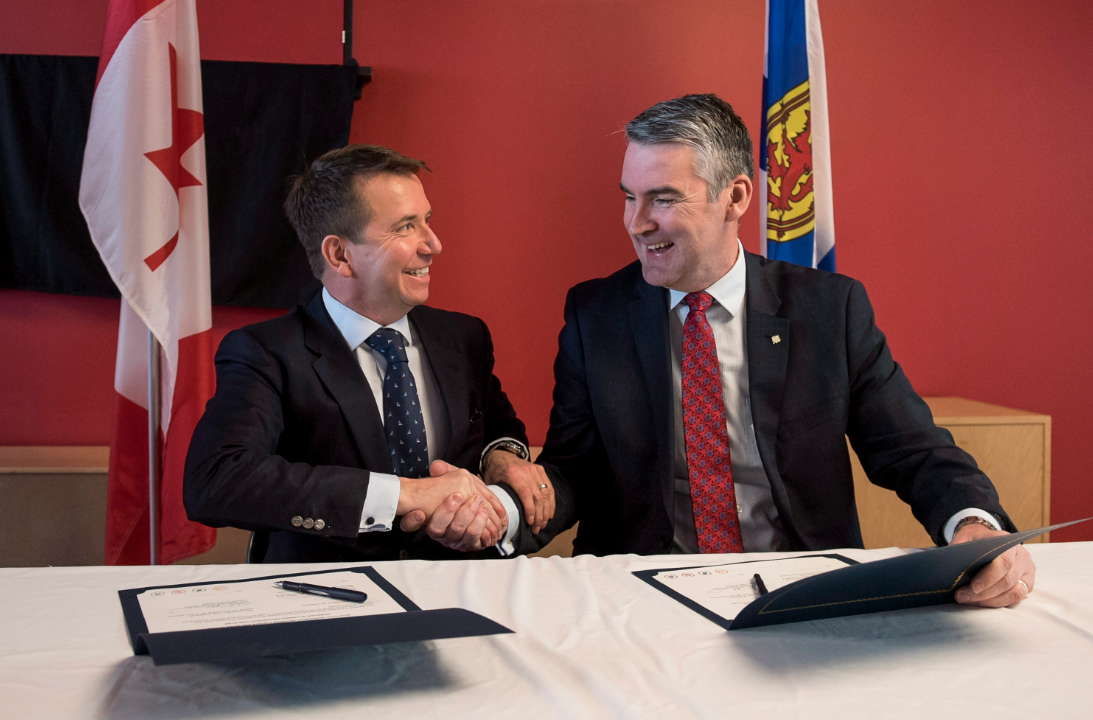 Scott Brison, left, MP for Kings-Hants, and Nova Scotia Premier Stephen McNeil shake hands after signing a bilateral agreement for more than $828 million over the next decade for infrastructure projects in Nova Scotia during a press conference in Halifax on Tuesday, April 10, 2018. (THE CANADIAN PRESS/Darren Calabrese).