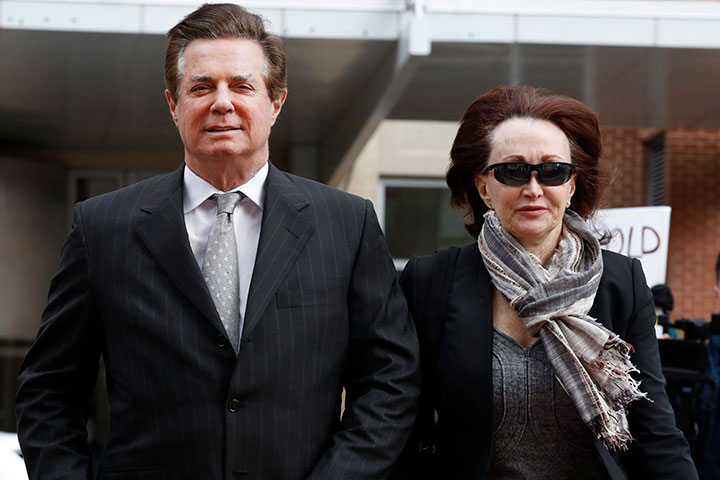 Paul Manafort, U.S. President Donald Trump's former campaign chairman, walks with this wife Kathleen Manafort, as they arrive at the Alexandria Federal Courthouse for an arraignment hearing on his Eastern District of Virginia charges, in Alexandria, Thursday, March 8, 2018. 