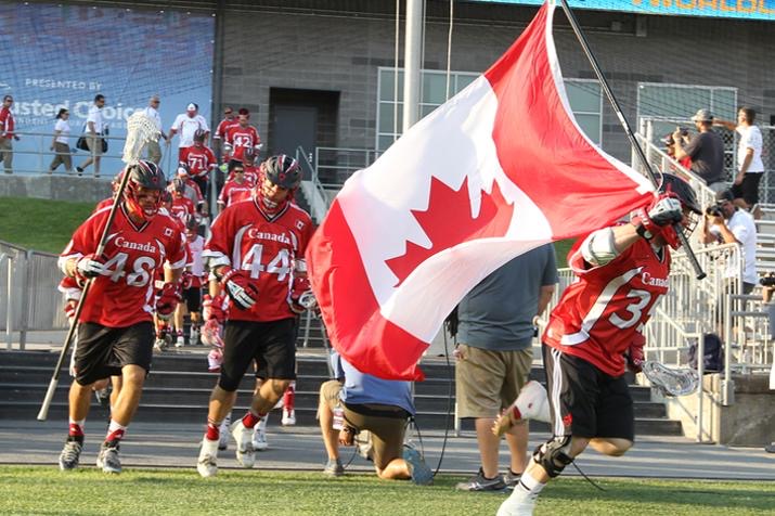 Geoff Snider carries the flag for Team Canada at the 2015 World Lacrosse Championships.