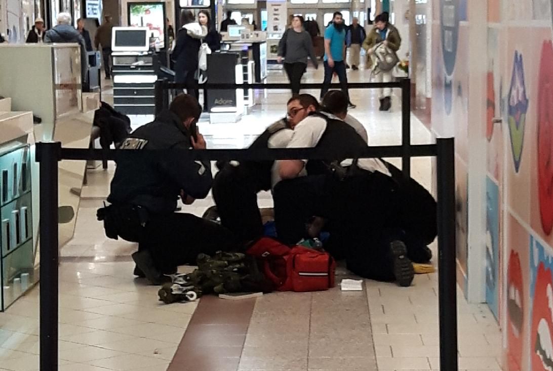 Southgate Centre security staff treating a man who was badly injured during a robbery inside Southgate Centre Tuesday morning during business hours. April 17, 2018.