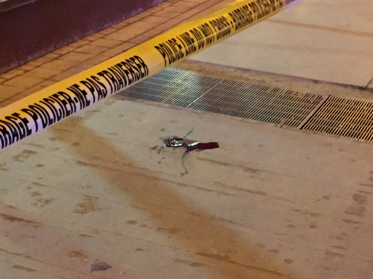 In front of Portage Place: police tape blocking off bus shelter, pool of blood seen on the ground.
