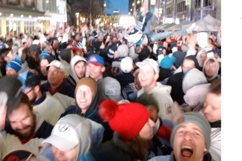 Fans enjoy the Winnipeg Whitout street party on Donald outside Bell MTS Place during Game 3.