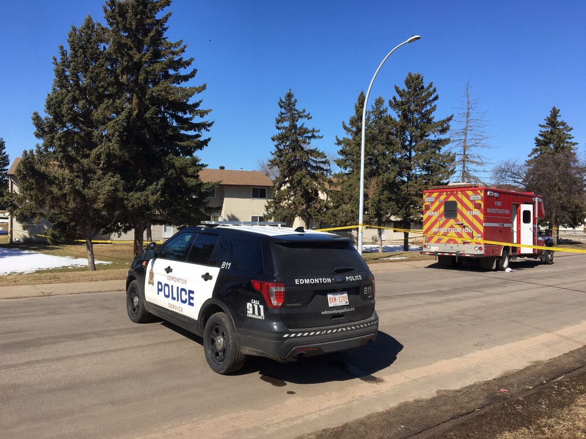 Police tape surrounds a north Edmonton townhouse where a man was found dead Wednesday, April 18, 2018. 