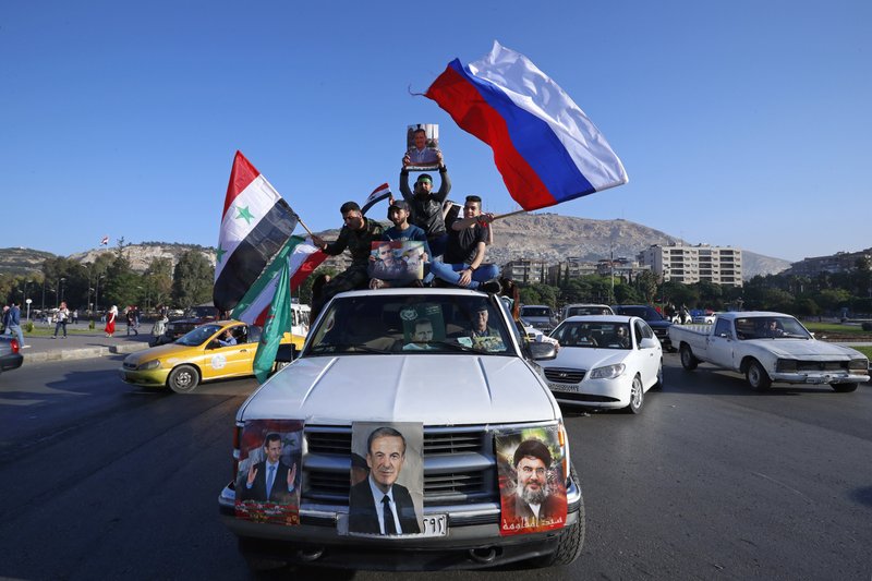 ×
None
Syrian government supporters wave Syrian, Iranian and Russian flags as they chant slogans against U.S. President Trump during demonstrations following a wave of U.S., British and French military strikes to punish President Bashar Assad for suspected chemical attack against civilians, in Damascus, Syria, Saturday, April 14, 2018. Hundreds of Syrians are demonstrating in a landmark square in the Syrian capital, waving victory signs and honking their car horns in a show of defiance. 