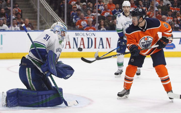 Vancouver Canucks' goalie Anders Nilsson (31) makes the save on Edmonton Oilers' Ty Rattie (8) during second period NHL action in Edmonton, Alta., on Saturday April 7, 2018. 