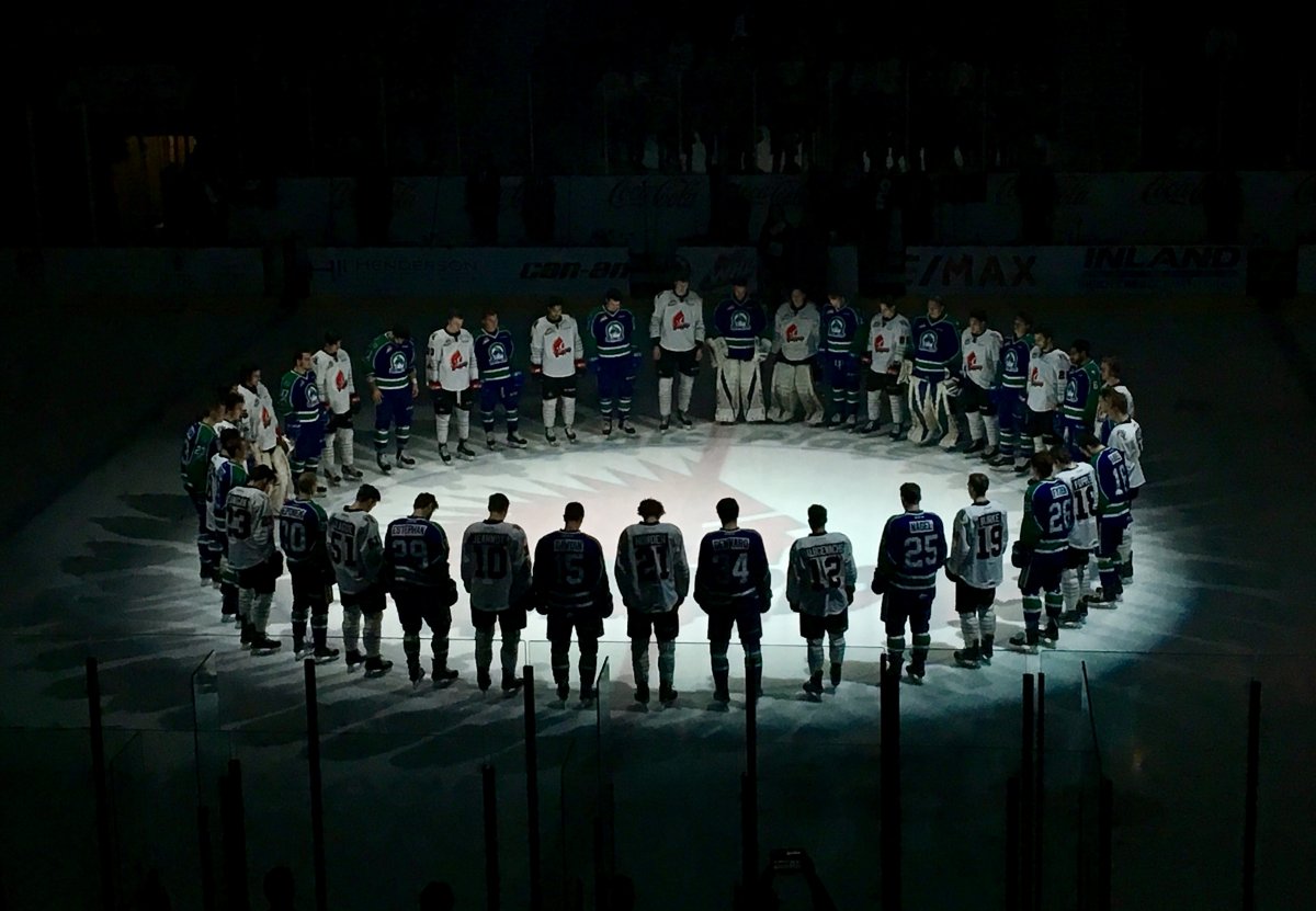 The Moose Jaw Warriors and Swift Current Broncos gather at centre ice for a moment of silence during their game at Mosaic Place on Saturday, April 7, 2018.