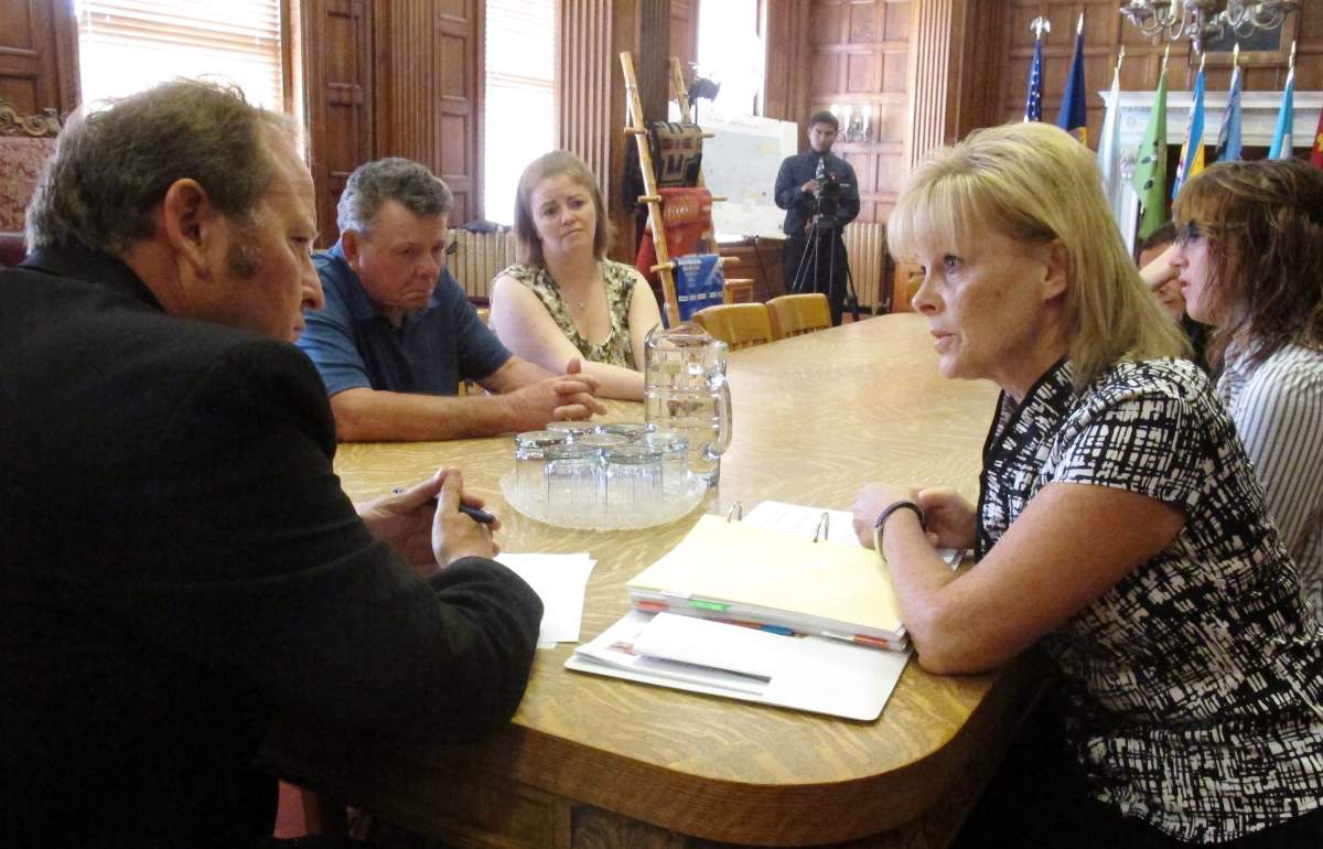 Montana Gov. Brian Schweitzer, left, is shown meeting with relatives of convicted murderer, Ronald A. Smith, who are seeking executive clemency for the death row inmate, Friday July 13, 2012 in Helena, Mont.