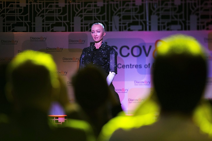 People gather to take photographs of Sophia the Robot which was created by David Hanson, founder and CEO, Chief Designer of Hanson Robotics in Toronto on Monday, April 30, 2018.  