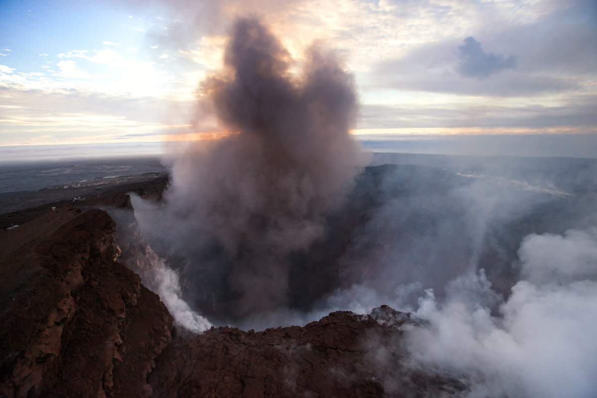 An aerial view taken during a Paradise Helicopters flight over the area shows smoke rising from the Pu’u ‘O’o crater on the Hawaii island. The crater’s floor collapsed on May 1 and is since then continuing to erode its walls and generating huge explosions of ashes.