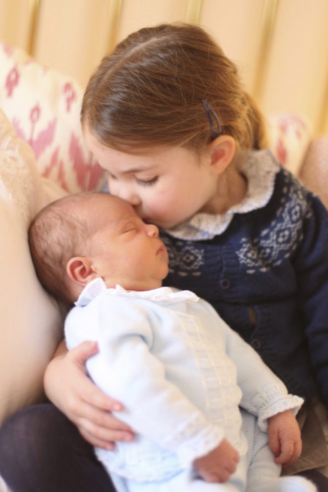 Britain's Princess Charlotte cuddles her brother Prince Louis, on her third birthday, at Kensington Palace, in London, May 2, 2018.
