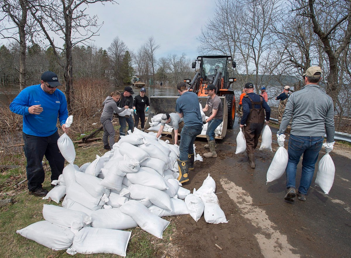 Residents and community volunteers load sandbags in Rothesay, N.B. on Sunday, May 6, 2018. 