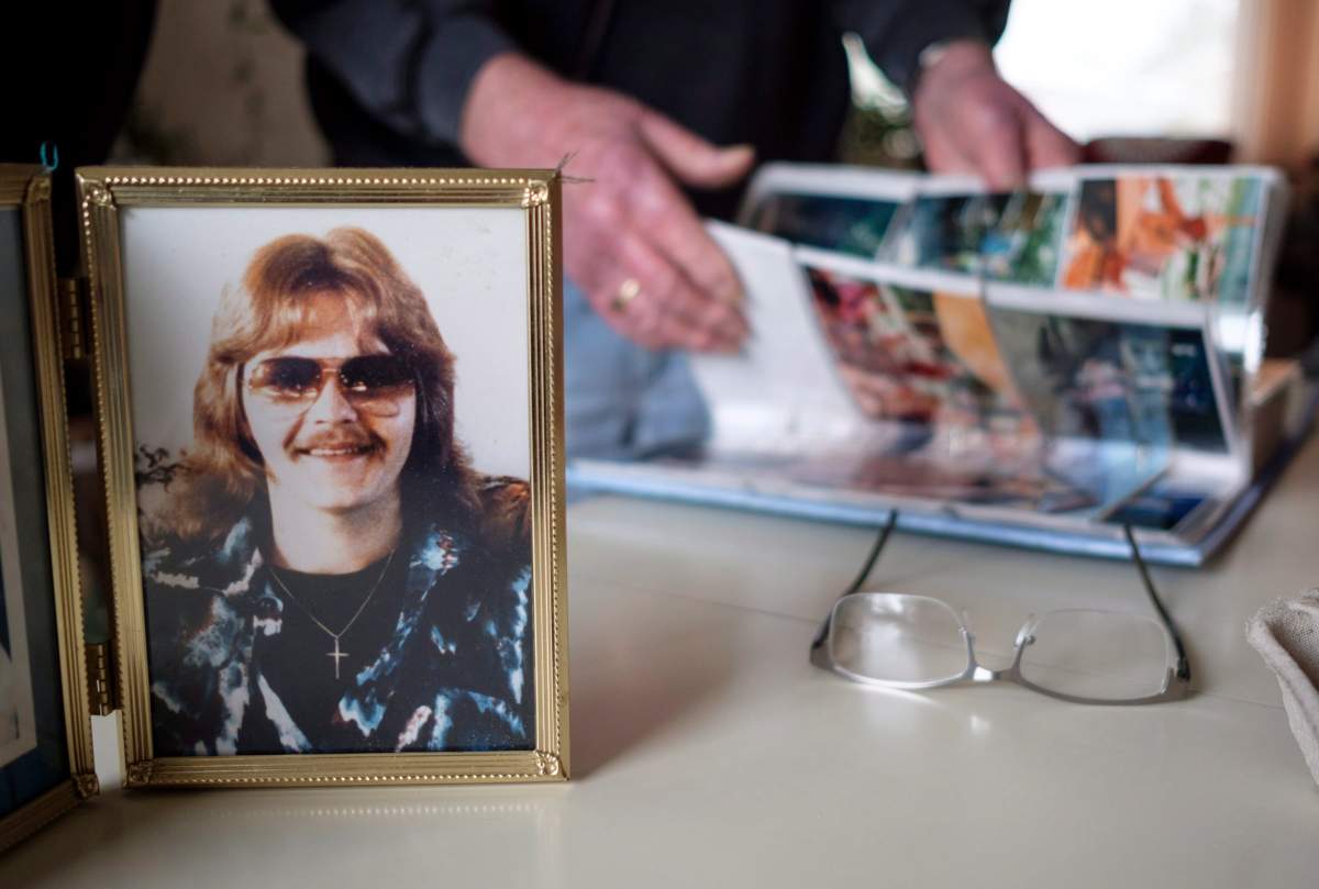 Nelson Smith, father of Canadian death row inmate Ronald Smith, looks through family photo albums as a photo of his son Ronald taken in the early 1980’s stands on a table at his home in Red Deer, Alta., Thursday, March 22, 2018.