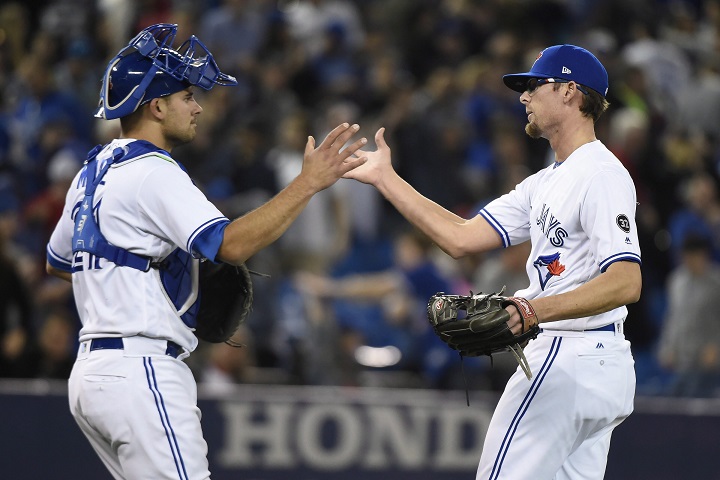 Toronto Blue Jays' Tyler Clippard celebrates with catcher Luke Maile after defeating the Seattle Mariners in American League MLB baseball action in Toronto on Wednesday.