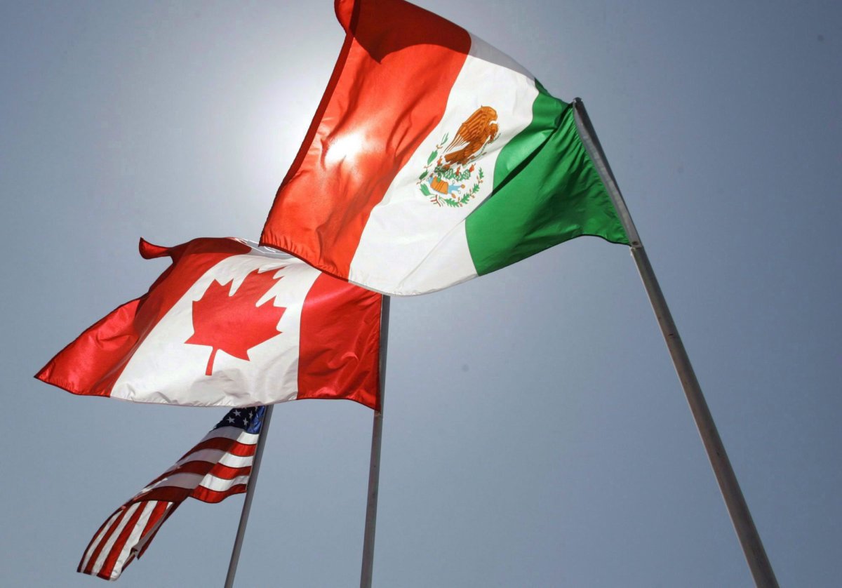 IIn this April 21, 2008 file photo, national flags of the United States, Canada, and Mexico fly in the breeze in New Orleans. Quebec's chief NAFTA negotiator says the US doesn't have the legal authority to sign a bilateral trade deal with Mexico. Monday, Aug/. 13, 2018.