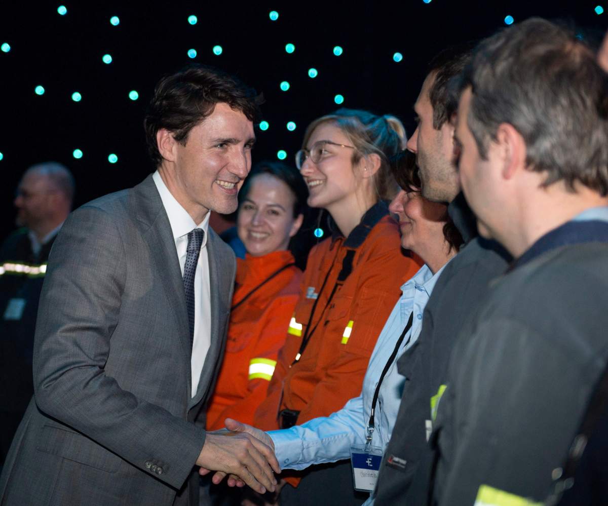 Prime Minister Justin Trudeau is greeted by aluminum plant workers at an announcement on clean aluminum smelting technology, Thursday, May 10, 2018 in Saguenay, Que. Those workers will soon be voters in a byelection Trudeau is expected to call as early as this weekend.
