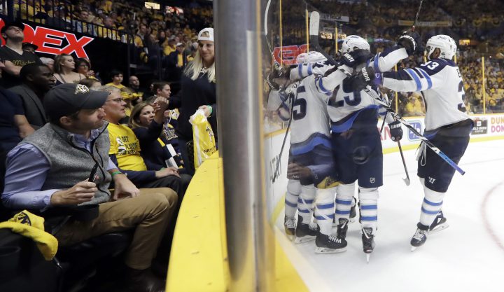 Winnipeg Jets center Paul Stastny (25) celebrates with Patrik Laine (29), of Finland, and Dustin Byfuglien (33) after Stastny scored a goal against the Nashville Predators during the third period in Game 7 of an NHL hockey second-round playoff series Thursday, May 10, 2018, in Nashville, Tenn. The Jets won 5-1 and advanced to the conference finals. (AP Photo/Mark Humphrey).