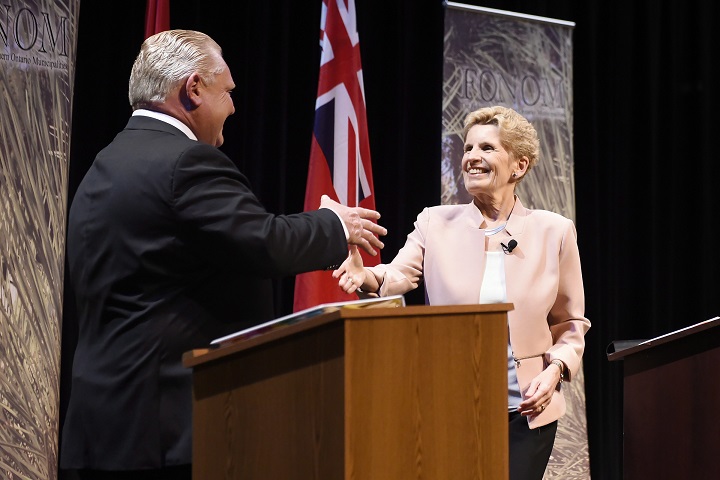 Ontario Progressive Conservative Leader Doug Ford, left, and Ontario Liberal Leader Kathleen Wynne shake hands after taking part in the second of three leaders' debate in Parry Sound, Ont., on Friday.
