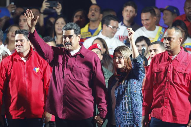 Venezuela's President Nicolas Maduro and his wife Cilia Flores wave to supporters after the National Electoral Council said he was re-elected in a vote marred by opposition boycott in Caracas, Venezuela, May 20, 2018.