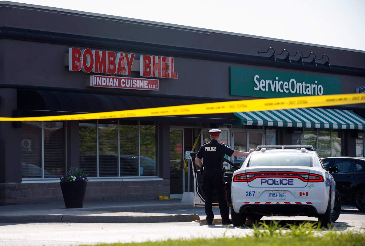 A police officer stands at the scene of an explosion at the Bombay Bhel restaurant in Mississauga, Ont. on Friday, May 25.