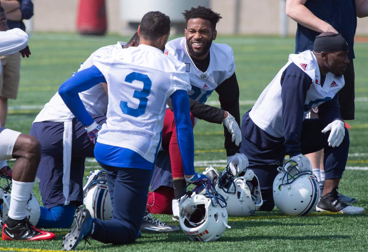 Montreal Alouettes wide receiver B.J. Cunningham, centre, chats with wide receiver Chris Williams during training camp in Montreal on Friday, May 25, 2018. THE CANADIAN PRESS/Paul Chiasson