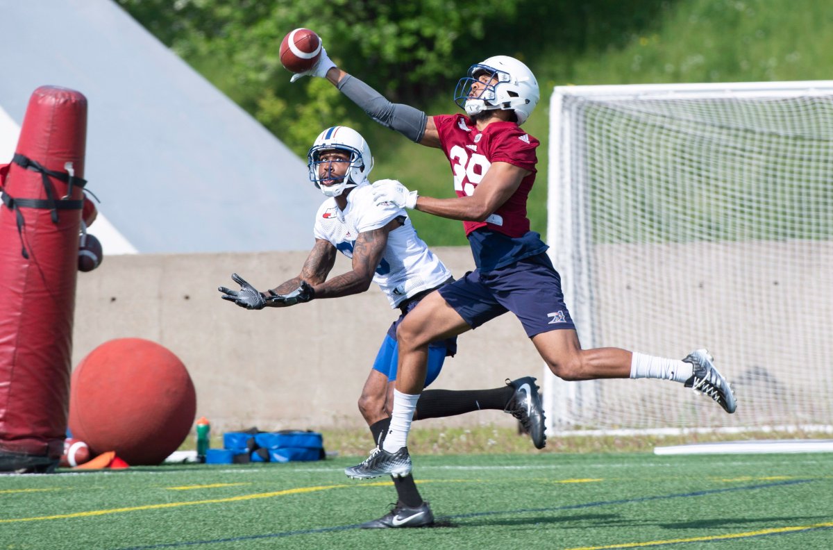 Montreal Alouettes defensive back Justin Gibbons tries to break up a pass intended for wide receiver Jamal Robinson during training camp in Montreal on Friday, May 25, 2018.