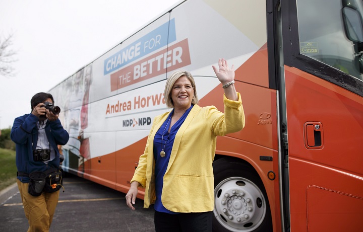 Ontario NDP Leader Andrea Horwath waves goodbye before boarding her bus as she leaves a campaign stop in Brampton, Ont., on Saturday. 