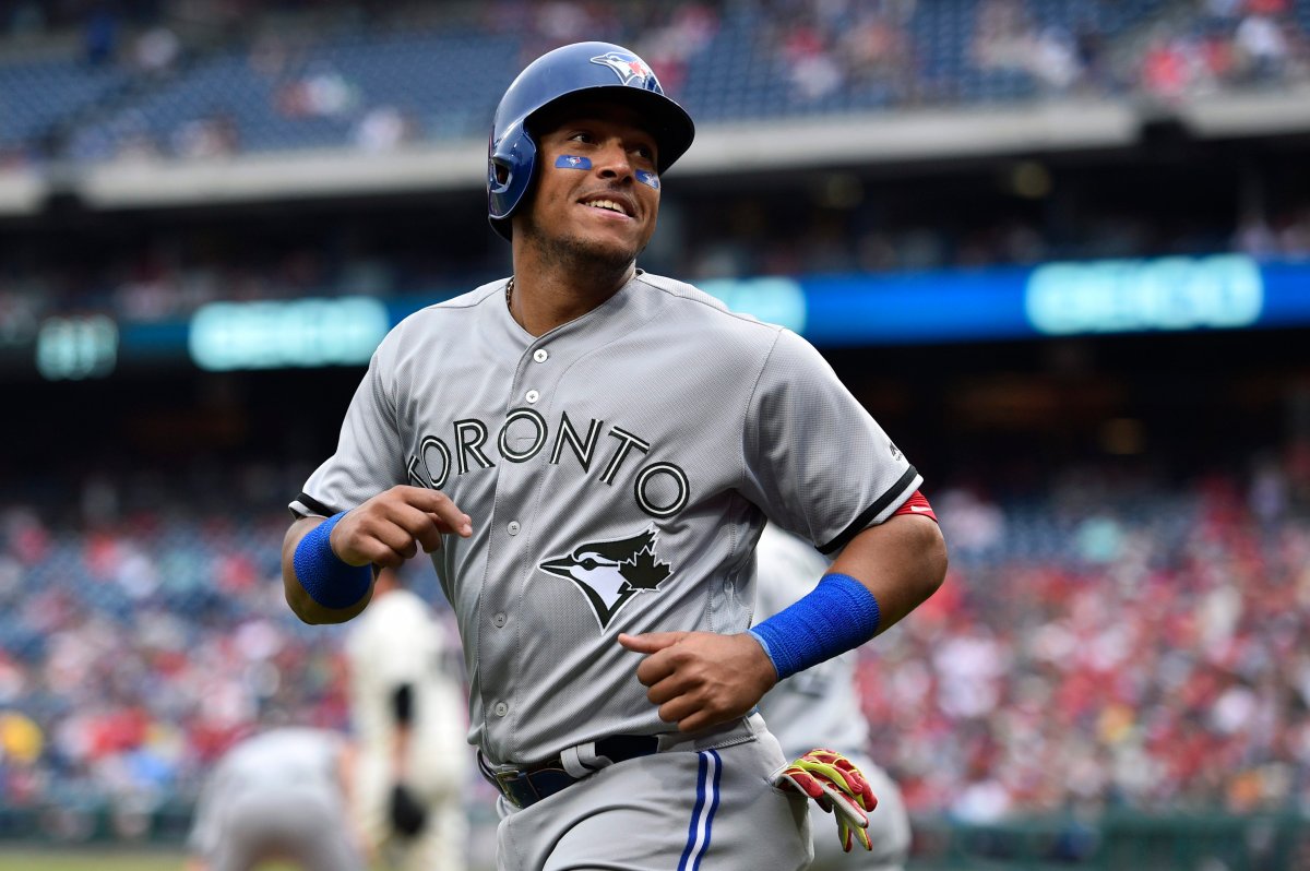 Toronto Blue Jays' Yangervis Solarte smiles after scoring on a double by Dwight Smith Jr. during the sixth inning of a baseball game against the Philadelphia Phillies, Sunday, May 27, 2018, in Philadelphia.