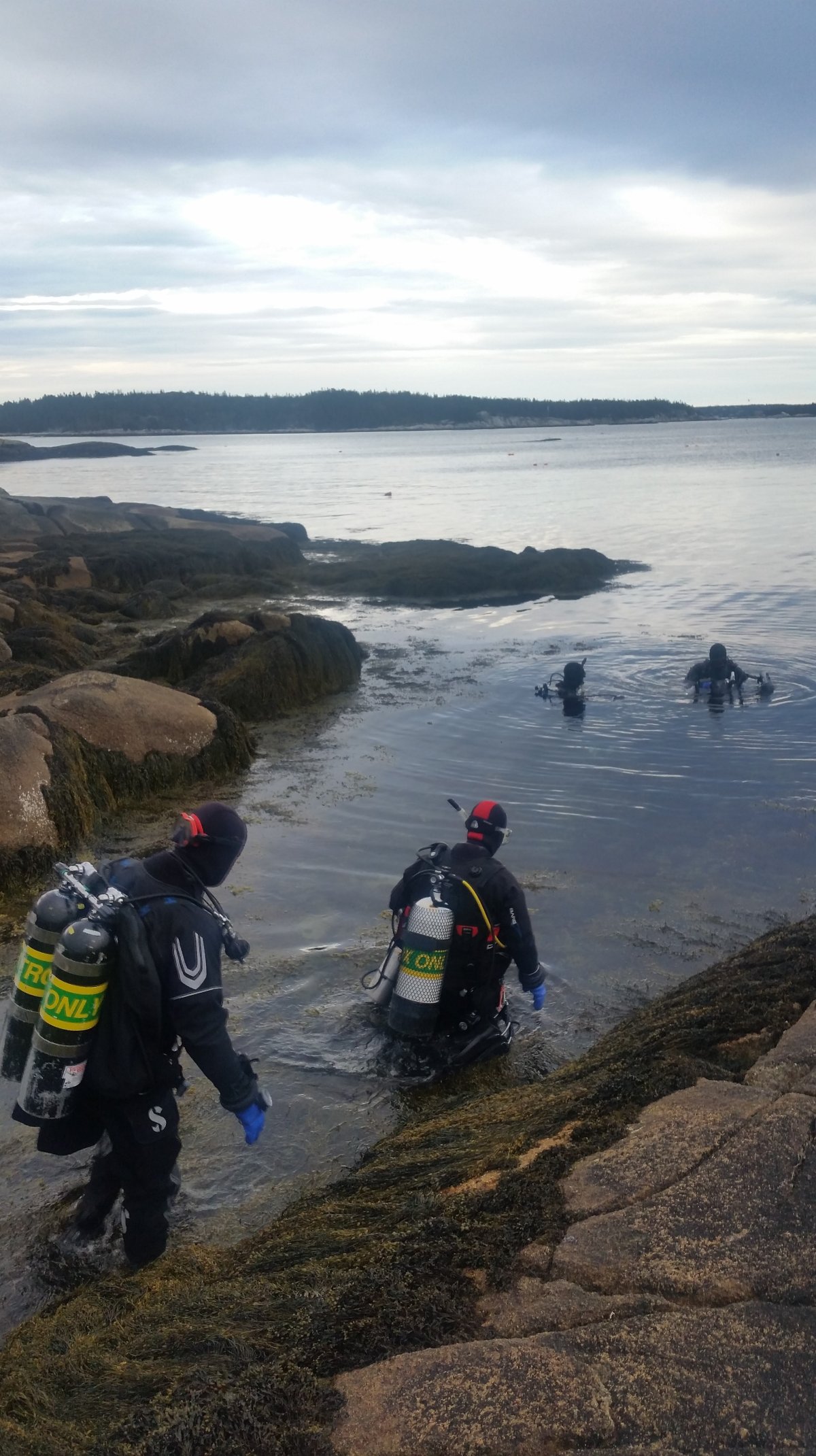 Scuba divers in Nova Scotia prepare to enter the waters of the Northwest Arm of the Atlantic Ocean.