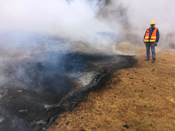 An HV0 geologist examines a part of the inactive fissure 10 in Leilani Estates in Hawaii, U.S. May 8, 2018. Picture taken on May 8, 2018.
