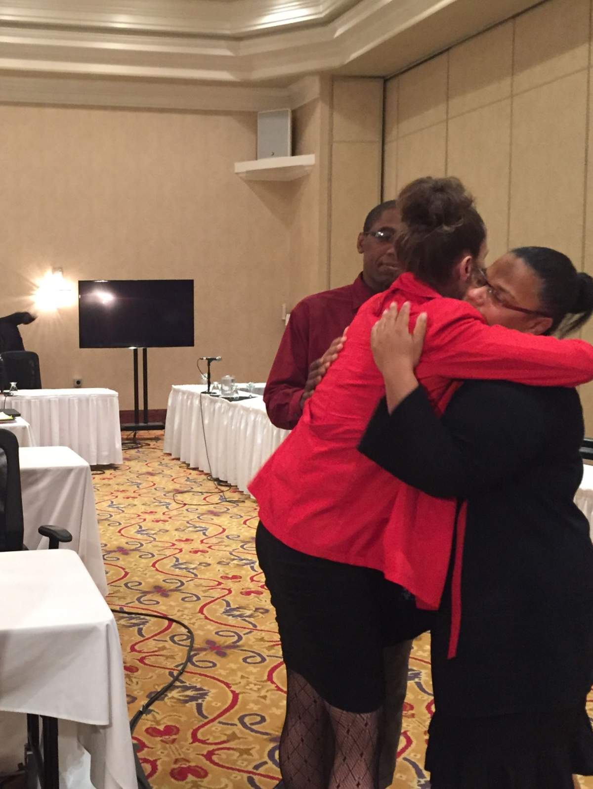 April Tykoliz hugs Cassandra and Glenroy Walton after hearing the verdict at the Barton Street jail inquest.