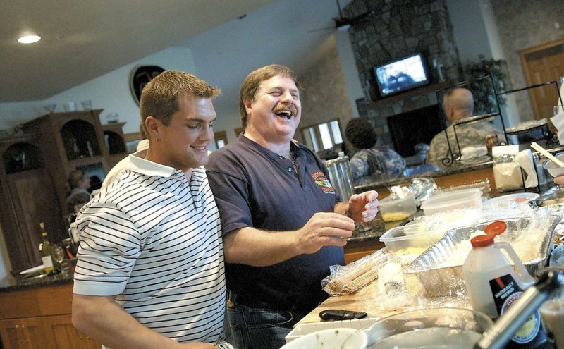 Boat engineer Blake Painter, left, with Capt. Rick Quashnick, right, at Quashnick's Warrenton, Ore., house to watch the Discovery Channel series 'The Deadliest Catch,' on April 18, 2006.