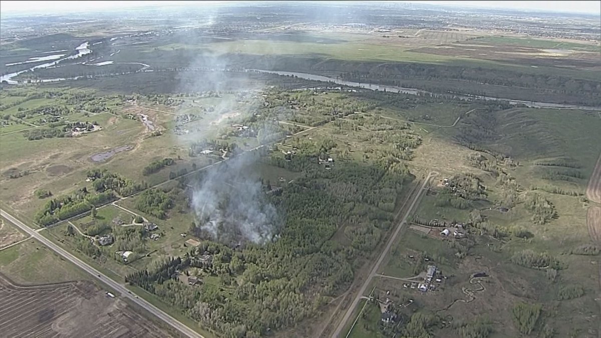 A brush fire burns near Dunbow Road East south of Calgary.
