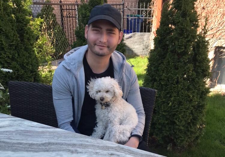 Alec Martel, 21, sits with his dog, Lilah. She was a gift after he was diagnosed with leukemia.