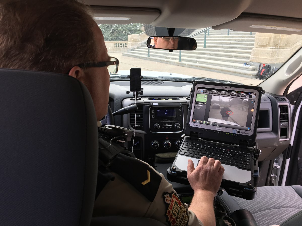 Conservation officer Lindsey Leko demonstrates how to use an automated license plate reader in Regina, SK.