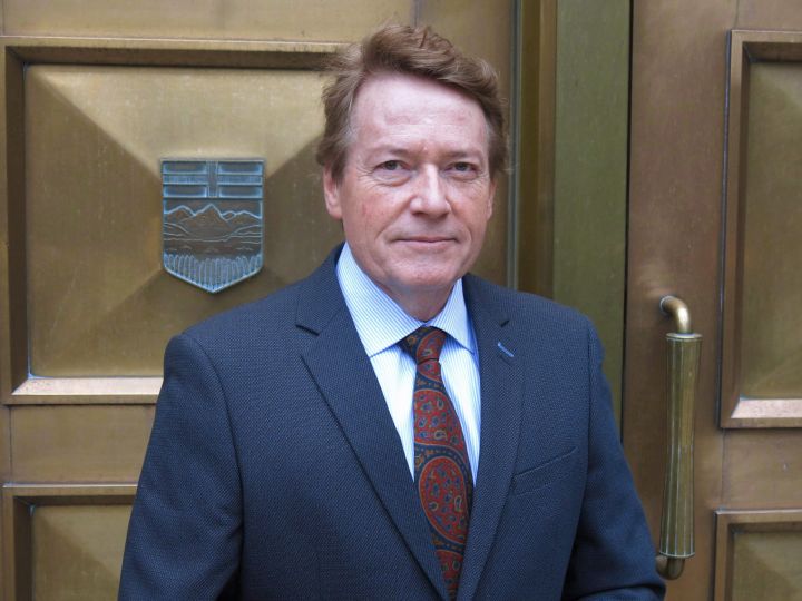 Former TV journalist Arthur Kent, who is suing PostMedia and columnist Don Martin for defamation, stops for a photo outside of the Calgary Courts Centre prior to the start of a four week defamation trial on Friday, Dec. 11, 2015. Kent has won a lawsuit against Postmedia and one of its columnists over an unflattering article that called the one-time TV reporter a "Dud Scud.".