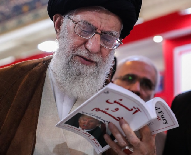 Ayatollah Ali Khamenei reads a copy of the book "Fire and Fury: Inside the Trump White House" at the 31st International Book Fair in Tehran, Iran, May 11, 2018.
