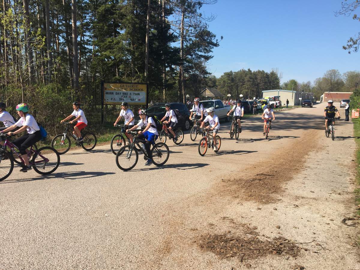 Bike-a-Thon participants leave the school to ride 30 km, under the supervision of police.